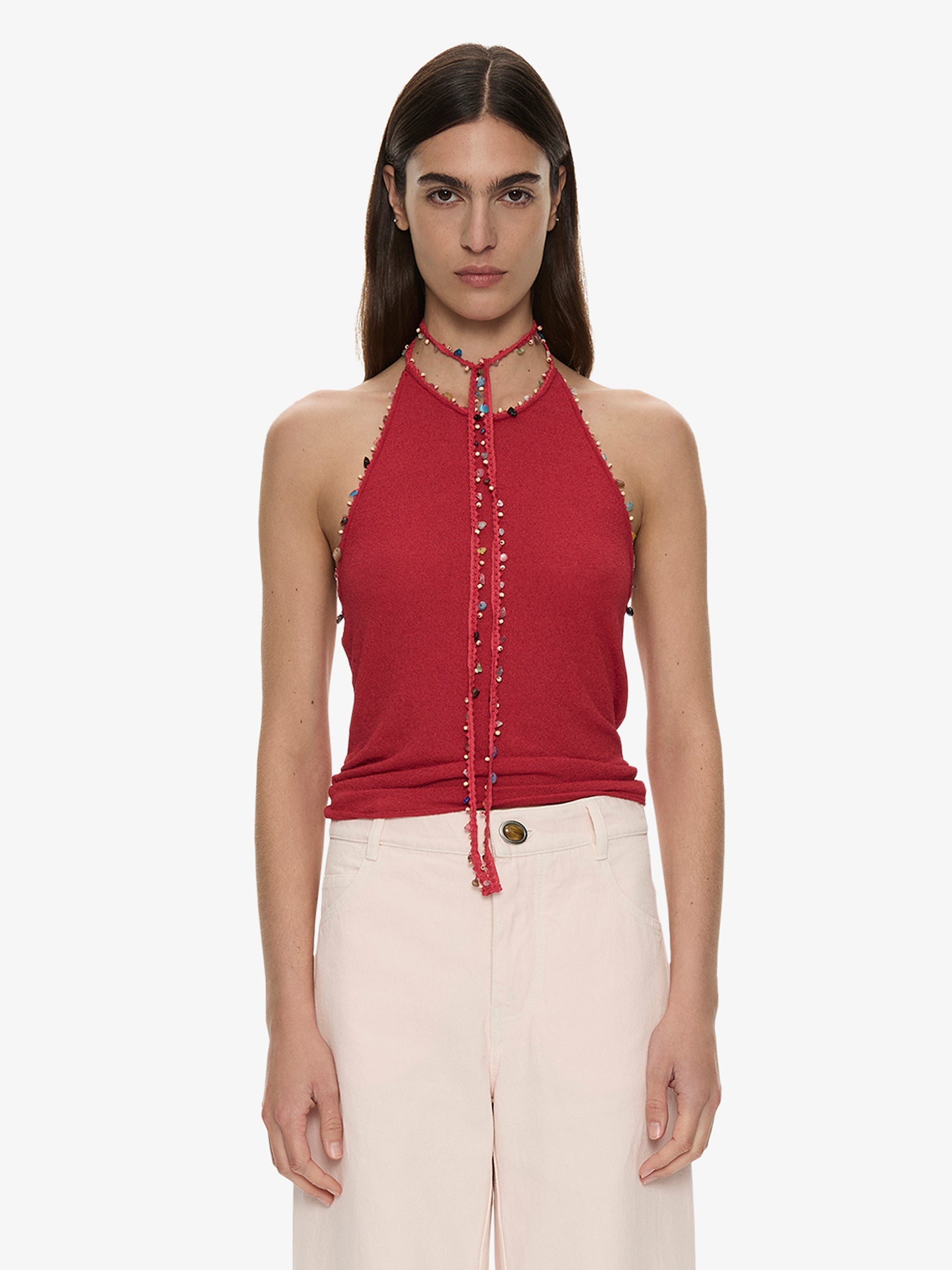 Image of a model wearing Tops. Product name - Beach Quartz Halter Tank in Red colour by brand - CHRISTOPHER ESBER