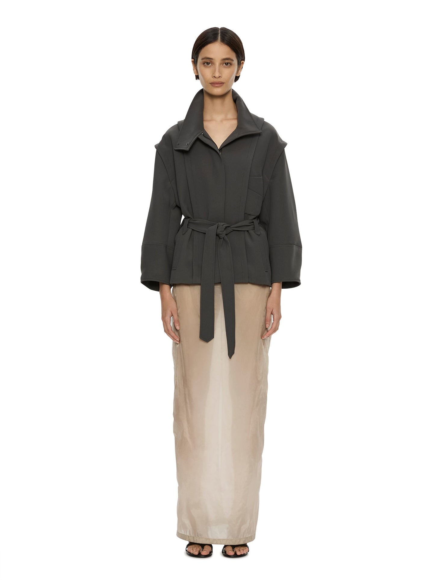 Image of a model wearing Outerwear. Product name - Virelle Parapet Drift Jacket in Green colour by brand - CHRISTOPHER ESBER