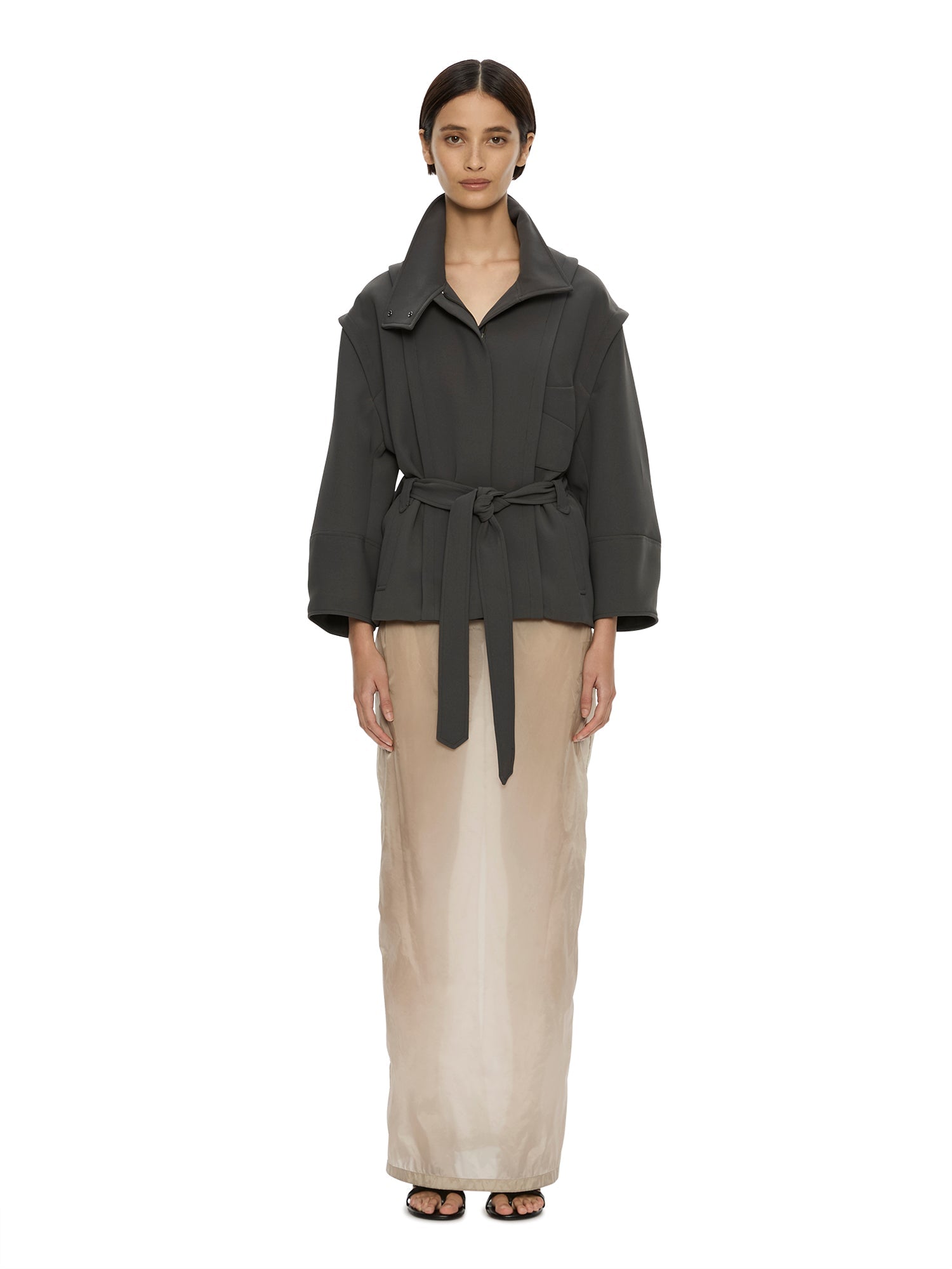Image of a model wearing Outerwear. Product name - Virelle Parapet Drift Jacket in Green colour by brand - CHRISTOPHER ESBER