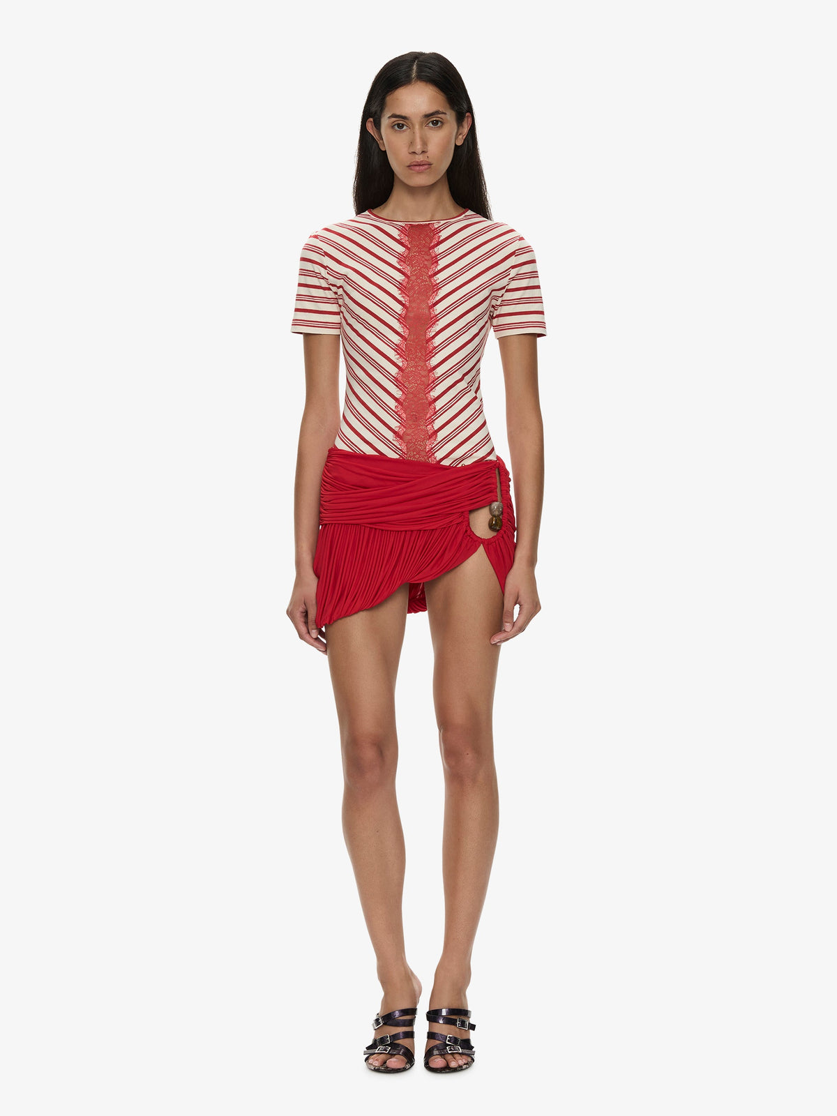 Image of a model wearing Skirts. Product name - Beach Glass Bubble Mini Skirt in Red colour by brand - CHRISTOPHER ESBER