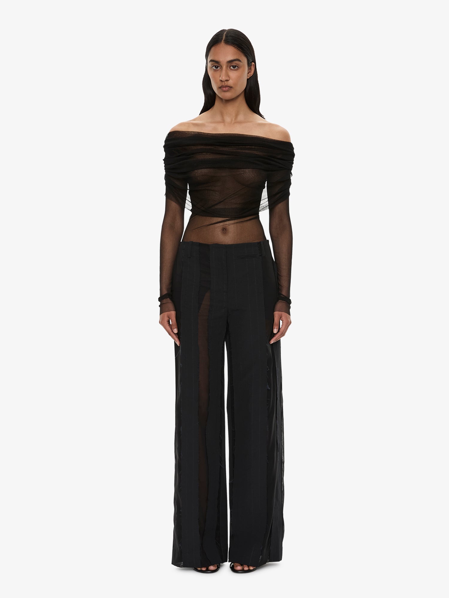 Image of a model wearing Pants. Product name - Ignis Spliced Trouser in Black colour by brand - CHRISTOPHER ESBER