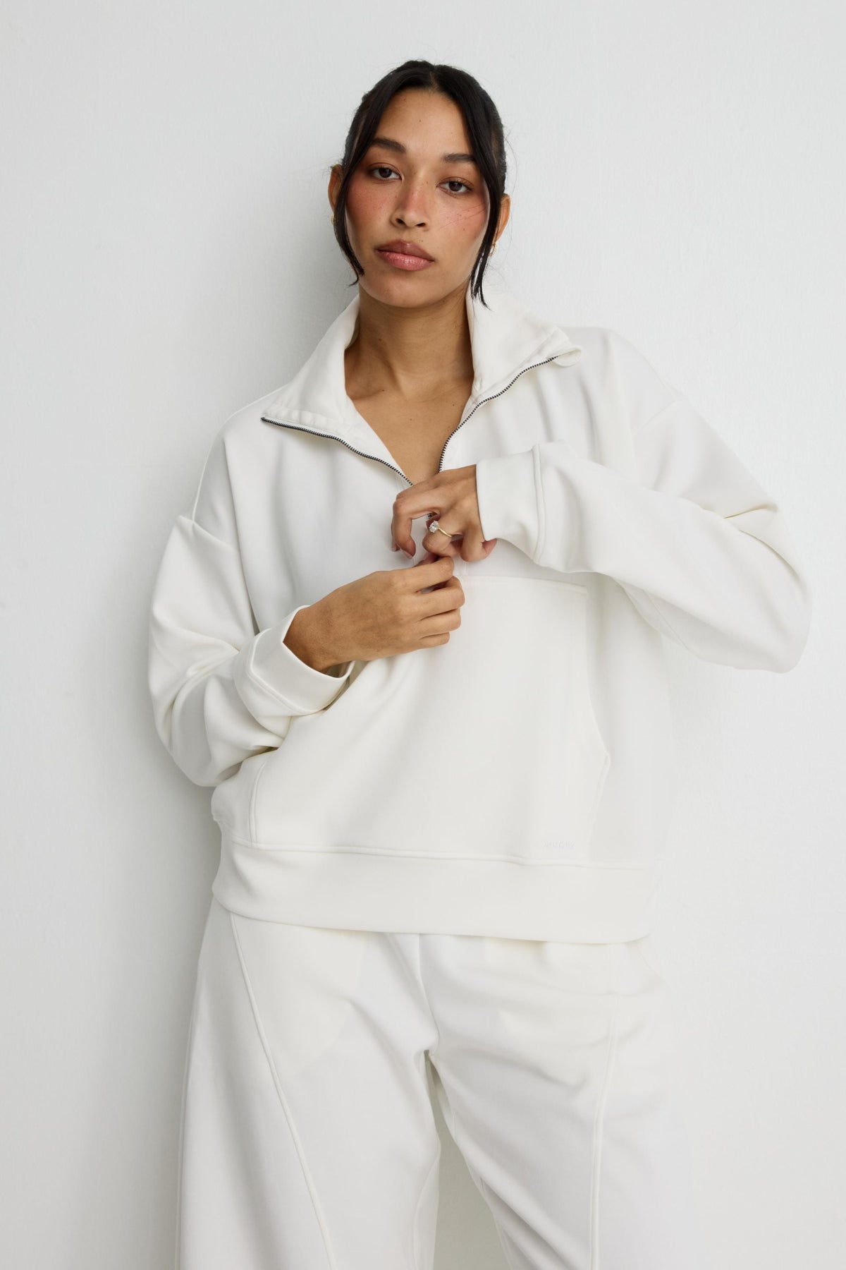 Image of a model wearing Outerwear. Product name - Soft Luxury 1/2 Zip Sweater in Chalk colour by brand - All Fenix