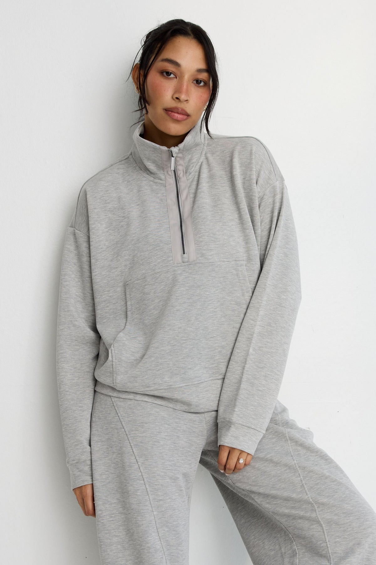 Image of a model wearing Outerwear. Product name - Soft Luxury 1/2 Zip Sweater in Grey colour by brand - All Fenix