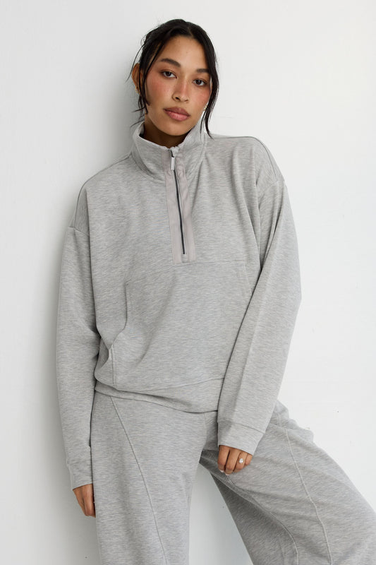 Image of a model wearing Outerwear. Product name - Soft Luxury 1/2 Zip Sweater in Grey colour by brand - All Fenix