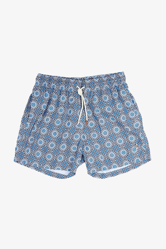 Image of a model wearing Shorts. Product name - Eufemia Blue Mediterranean Swim Shorts in Blue colour by brand - Anthony Squires