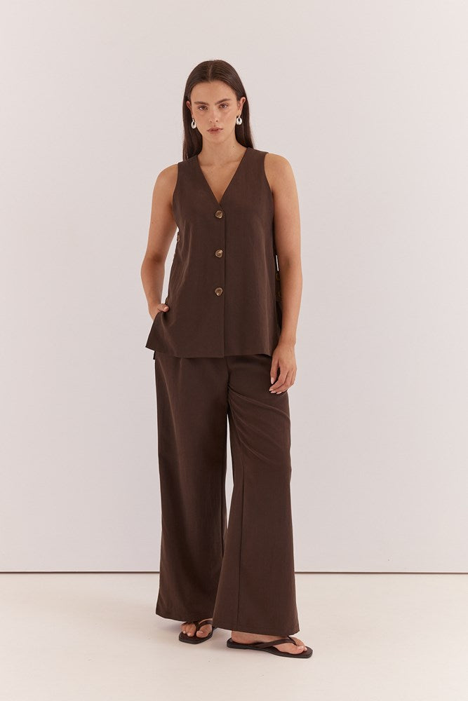 Image of a model wearing Pants. Product name - Natalie Wide Leg Trouser Chocolate in Chocolate colour by brand - Sass Clothing