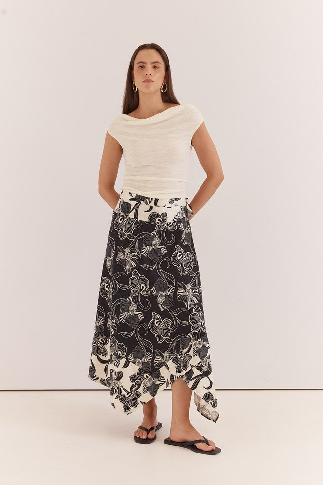 Image of a model wearing Skirts. Product name - Maribel Asym Wrap Skirt in Snap Dragon colour by brand - Sass Clothing