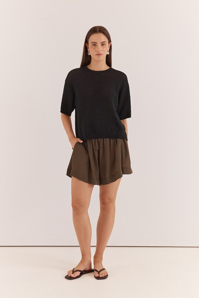 Image of a model wearing Tops. Product name - Noni Relaxed Knit Tee in Black colour by brand - Sass Clothing
