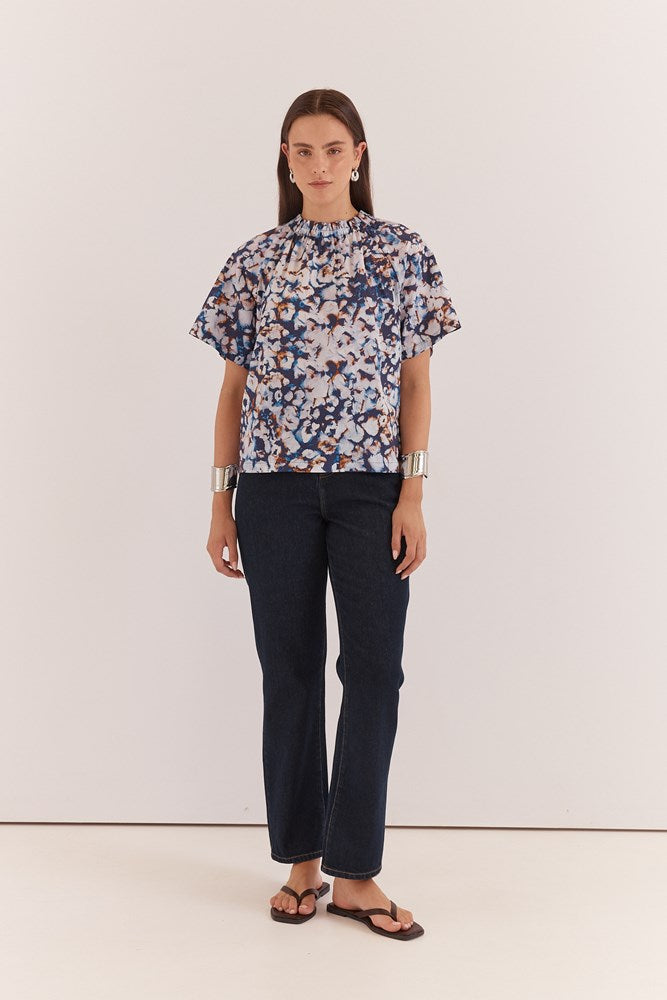 Image of a model wearing Tops. Product name - Anika Frill Neck Blouse Violet Floral in Violet Floral colour by brand - Sass Clothing