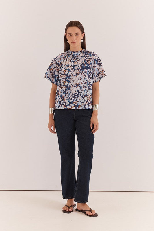 Image of a model wearing Tops. Product name - Anika Frill Neck Blouse Violet Floral in Violet Floral colour by brand - Sass Clothing