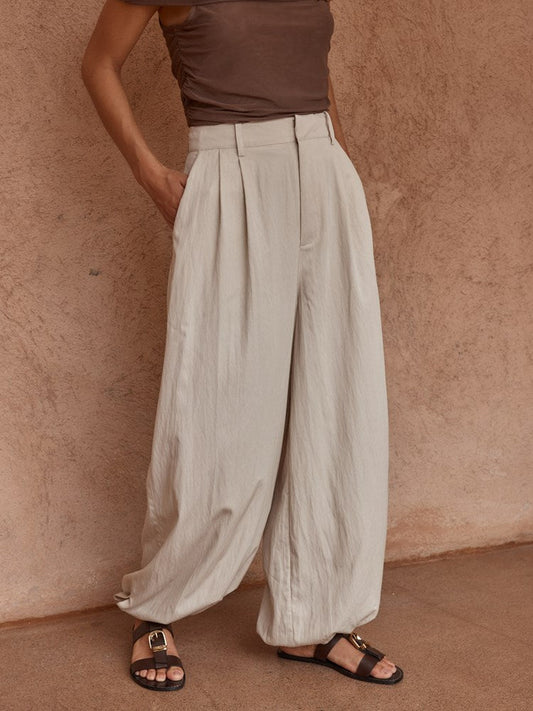 Image of a model wearing Pants. Product name - Lucie Soft Balloon Pant Stone in Stone colour by brand - Sass Clothing