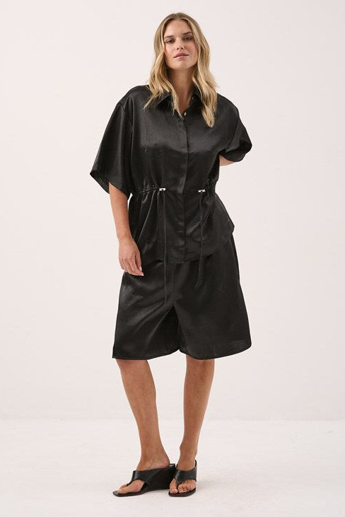 Image of a model wearing Shorts. Product name - Lina Bermuda Short Black in Black colour by brand - Sass Clothing