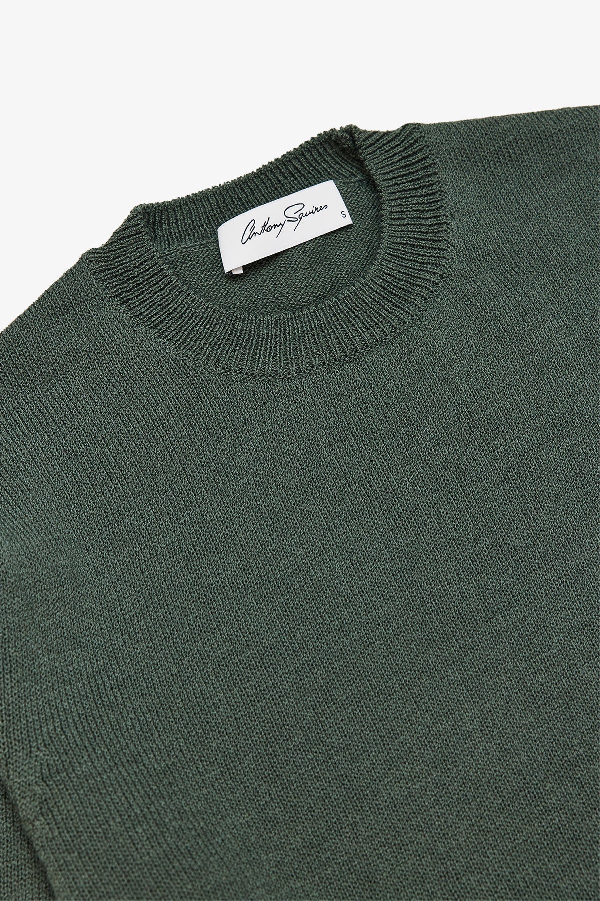 Image of a model wearing Tops. Product name - Asher Green Crewneck Knit in Green colour by brand - Anthony Squires