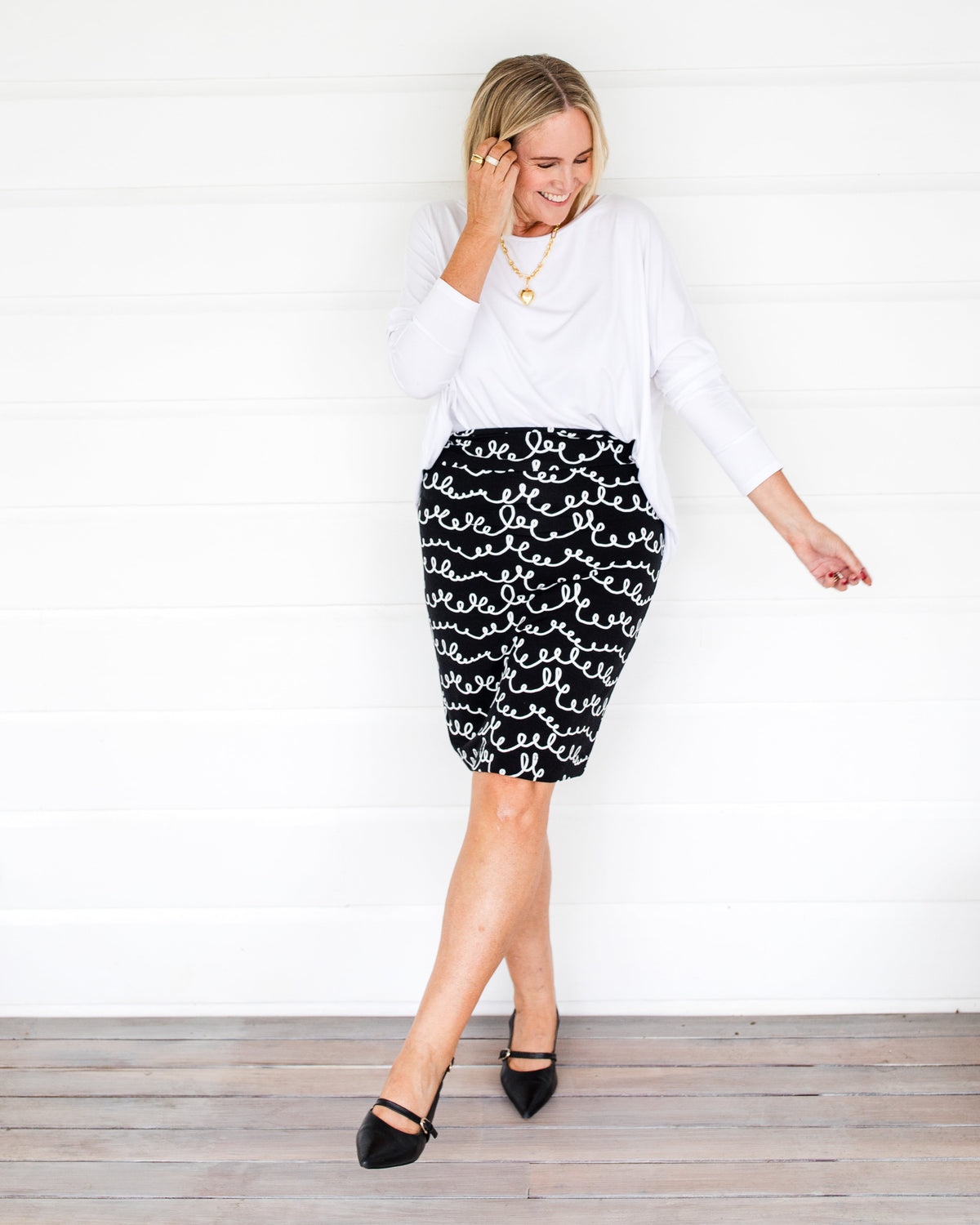 Image of a model wearing Skirts. Product name - Midi Bamboo Whitney Tube Skirt Squiggle Print in Squiggle colour by brand - Lou Lou