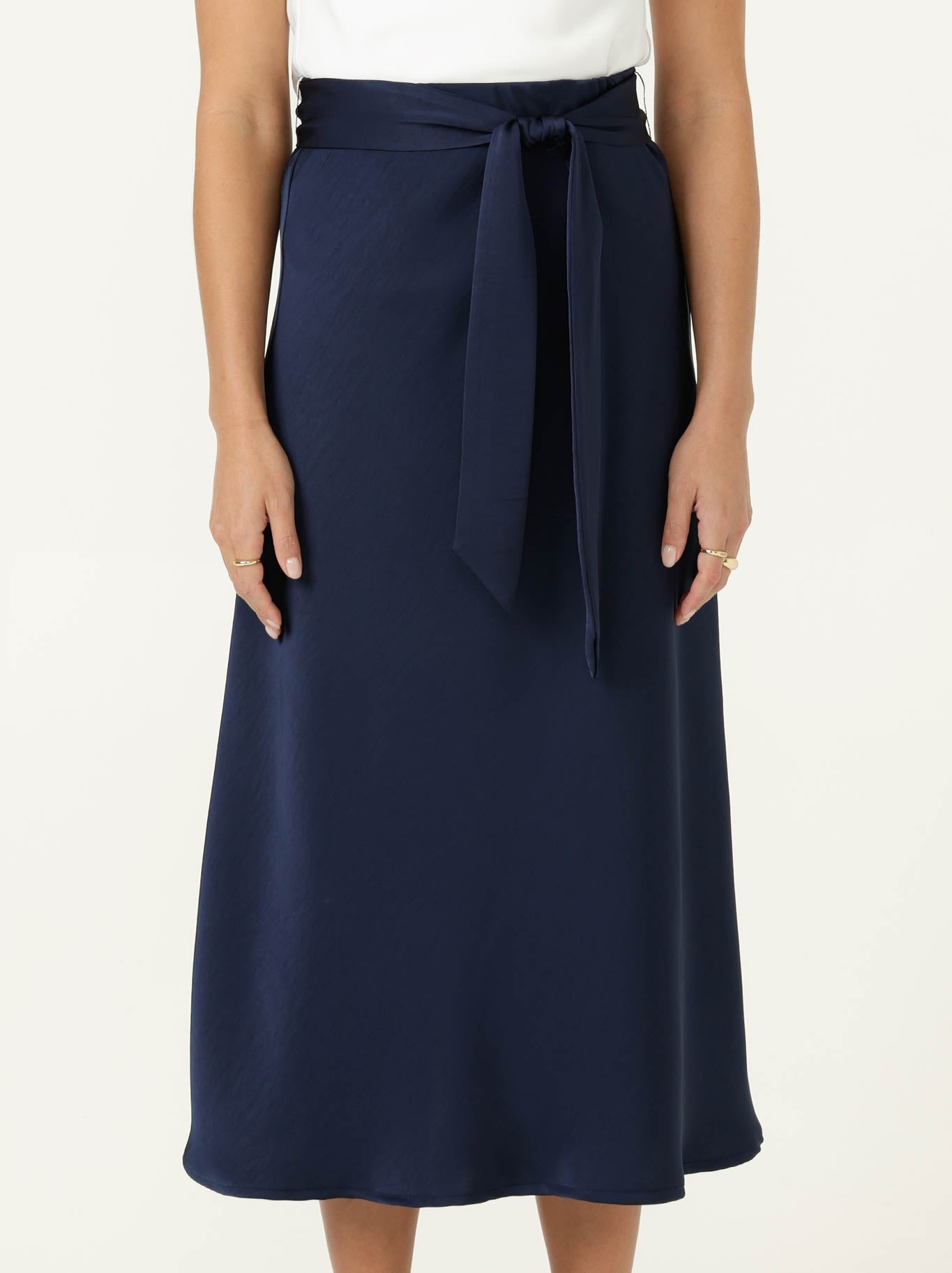 Image of a model wearing Skirts. Product name - SACHA DRAKE LUXE BIAS SKIRT in Navy colour by brand - Sacha Drake