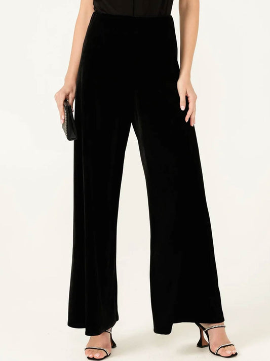 Image of a model wearing Pants. Product name - Sacha Drake Plush Palazzo Pant in Black colour by brand - Sacha Drake
