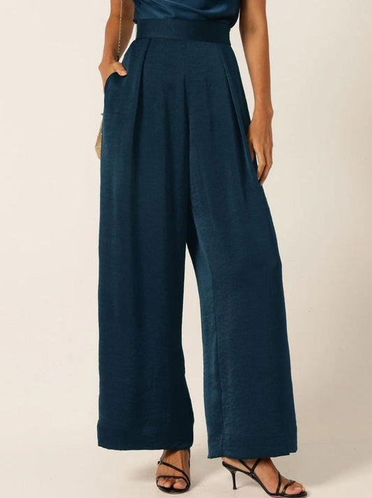Image of a model wearing Pants. Product name - Sacha Drake Pleated Trouser in Steele Blue colour by brand - Sacha Drake Pty Ltd