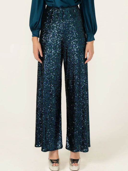 Image of a model wearing Pants. Product name - SACHA DRAKE SEQUIN PALAZZO PANT in Peacock colour by brand - Sacha Drake Pty Ltd