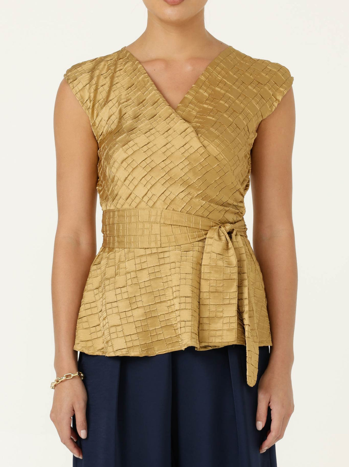 Image of a model wearing Tops. Product name - Sacha Drake Sylvia Top in Gold colour by brand - Sacha Drake