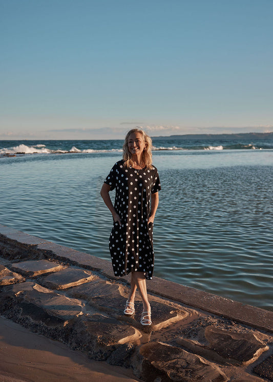 Image of a model wearing Skirts. Product name - Sade Bamboo Oversized T-Shirt Midi Dress Polka Dot in Polka Dot colour by brand - Lou Lou