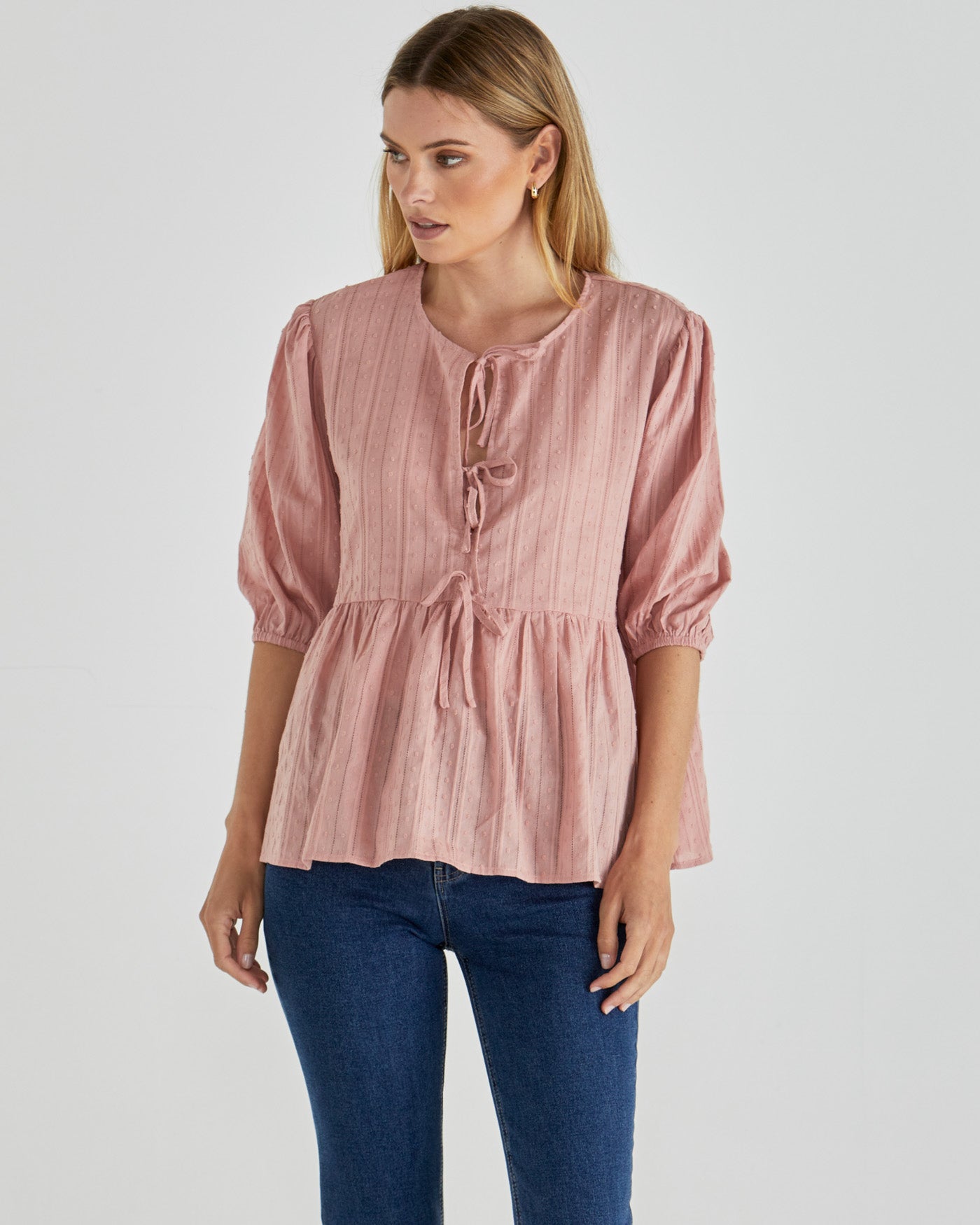 Image of a model wearing Tops. Product name - Rachael Top Pink in Pink colour by brand - Sass Clothing