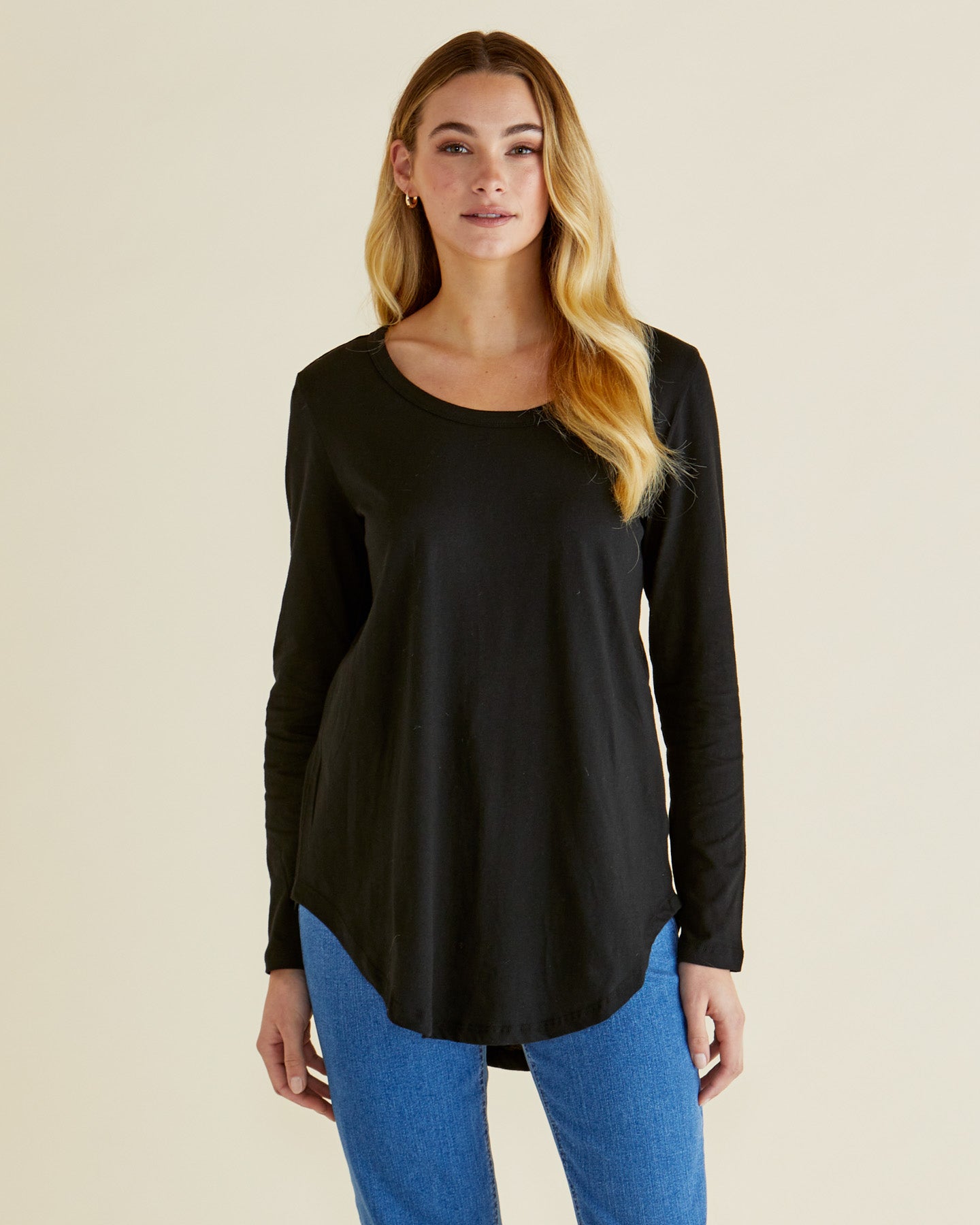 Image of a model wearing Tops. Productname: Betty Basics Megan Long Sleeve Top Black in Black colour by brand - Betty Basics