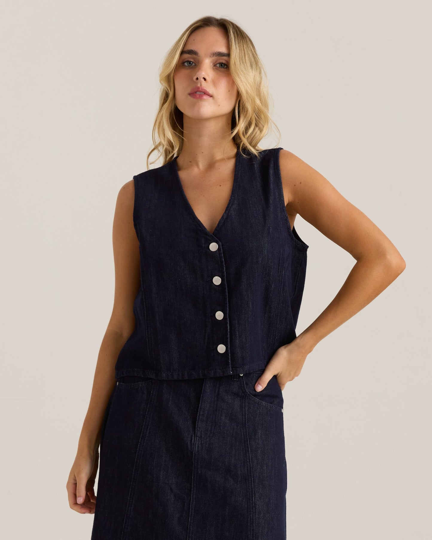 Image of a model wearing Tops. Product name - Sabine Denim Vest Dark Rinse Wash in Dark Rinse Wash colour by brand - Sass Clothing