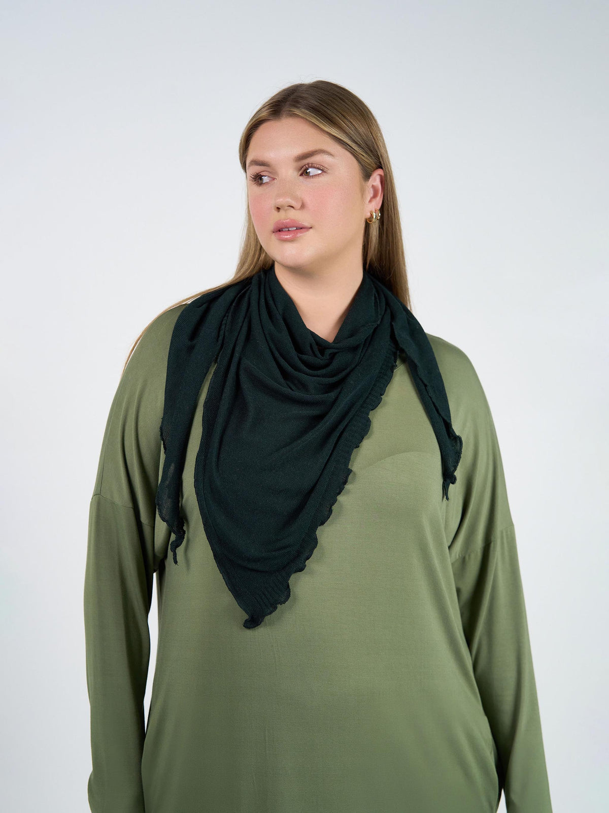 Image of a model wearing Tops. Product name - Sassoon Cashmere/Bamboo Scarf Dark Green in Dark Green colour by brand - Lou Lou
