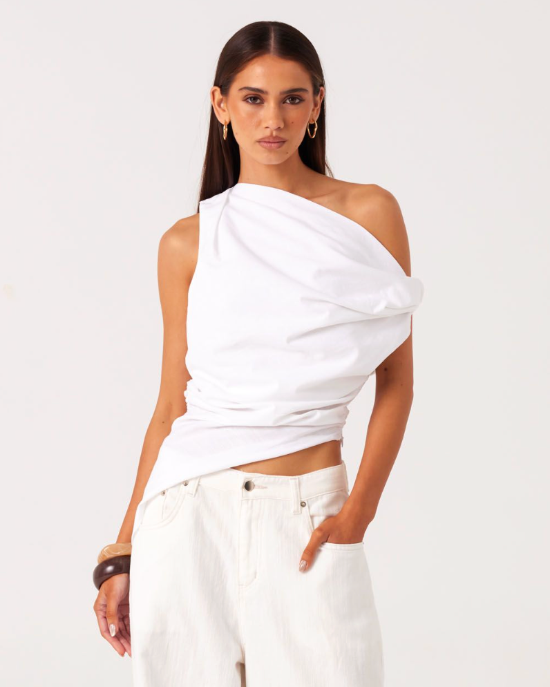 Image of a model wearing Tops. Productname: SNDYS CALISSA ASYMMETRICAL TOP in White colour by brand - SNDYS
