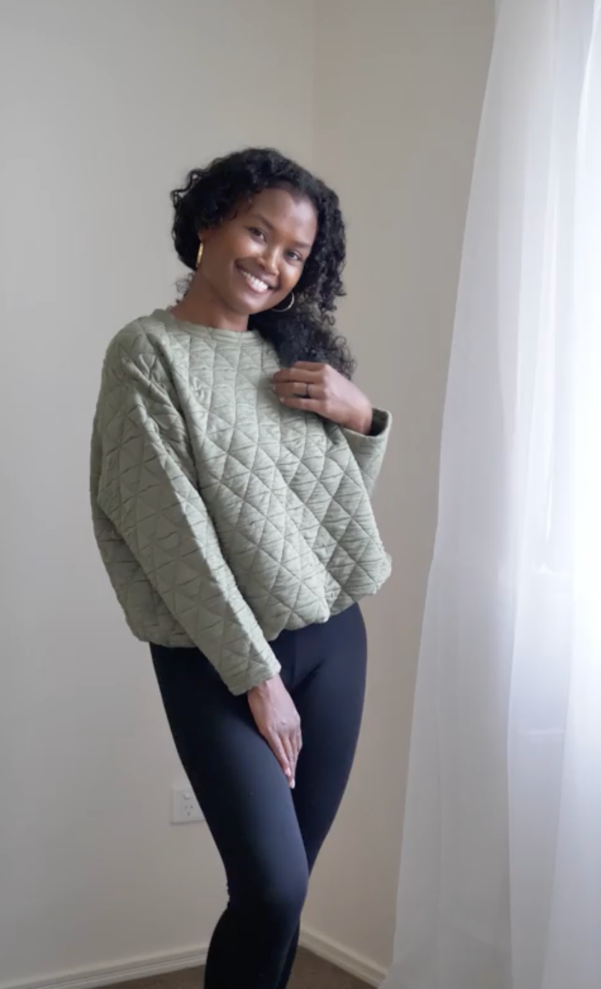 Image of a model wearing Tops. Product name - Sacha Oversized Quilted Bamboo Sweater in Olive colour by brand - Lou Lou