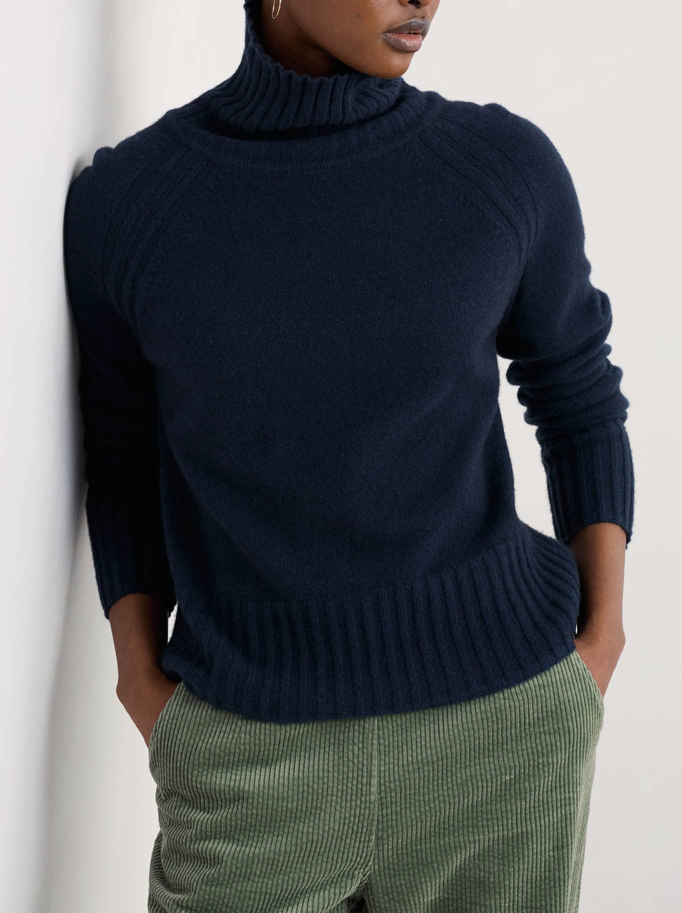 Image of a model wearing Outerwear. Product name - Seasalt Basset Cove Jumper in Maritime colour by brand - Seasalt