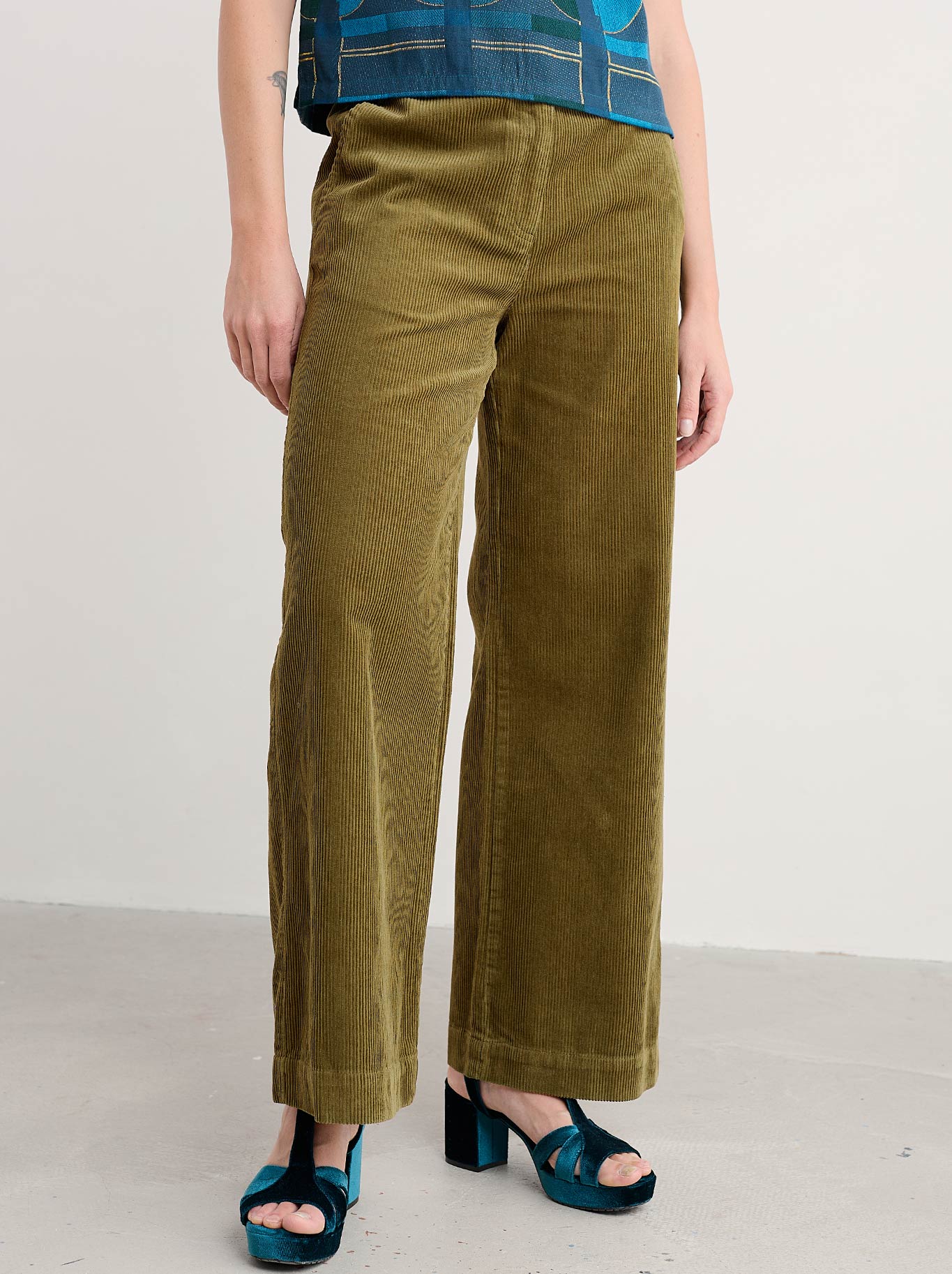 Image of a model wearing Pants. Product name - Seasalt Dillwyn Trouser in Bright Olive colour by brand - Seasalt
