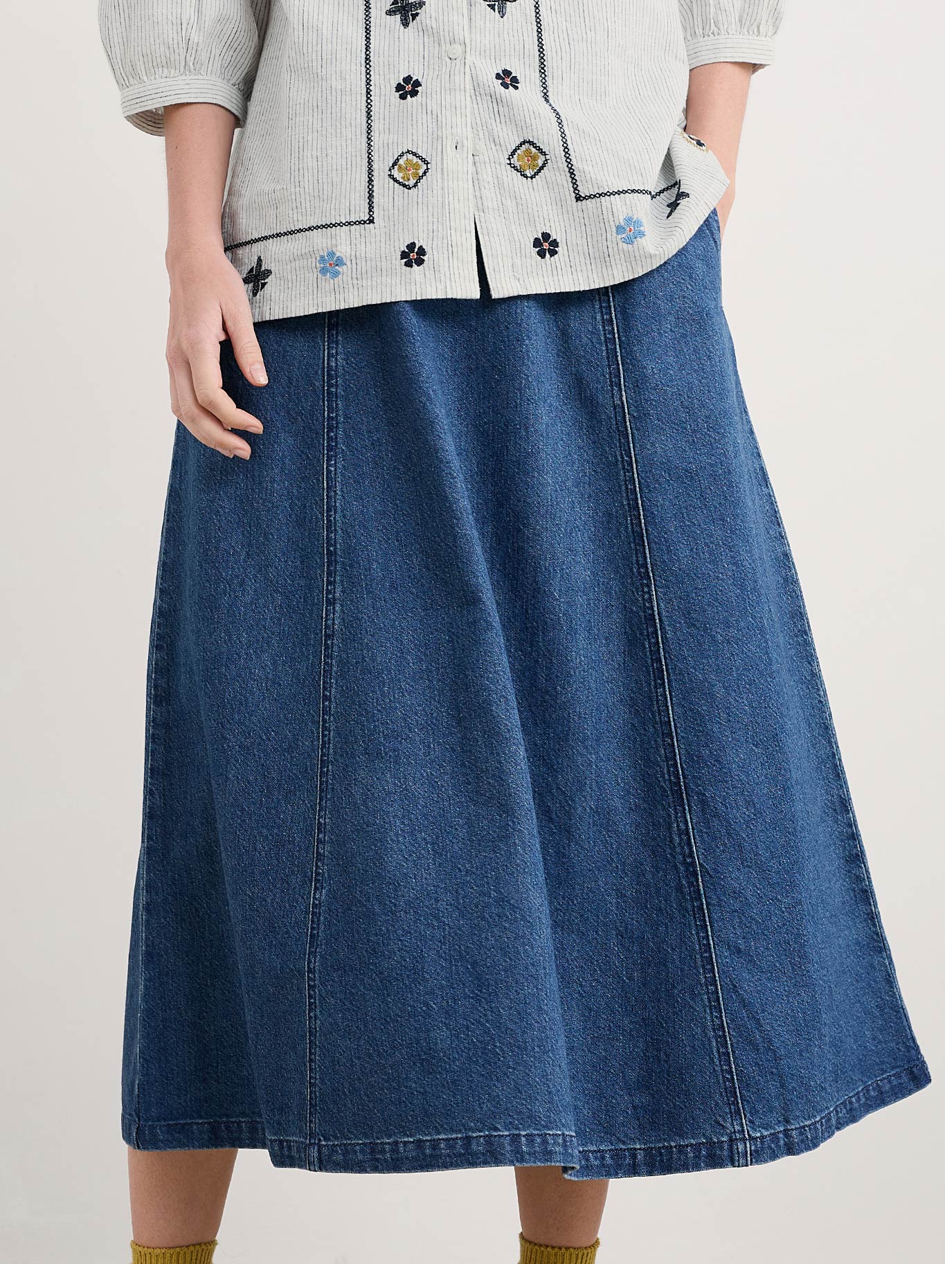 Image of a model wearing Skirts. Product name - Seasalt Restharrow Skirt in Mid Wash colour by brand - Seasalt