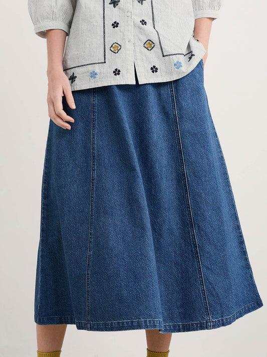 Image of a model wearing Skirts. Product name - Seasalt Restharrow Skirt in Mid Wash colour by brand - Seasalt