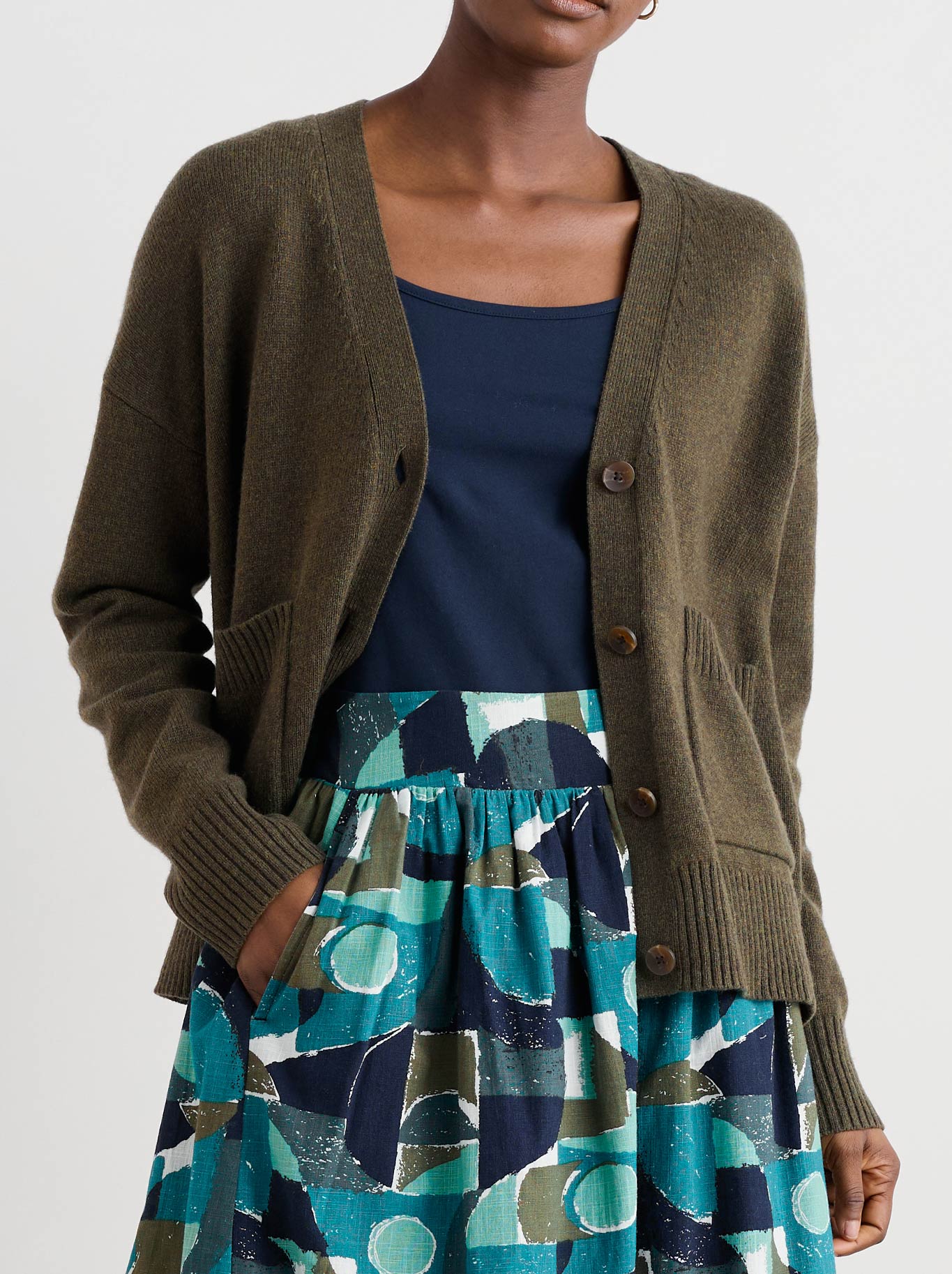 Image of a model wearing Outerwear. Product name - Seasalt Senara Cardigan in Rich Olive colour by brand - Seasalt