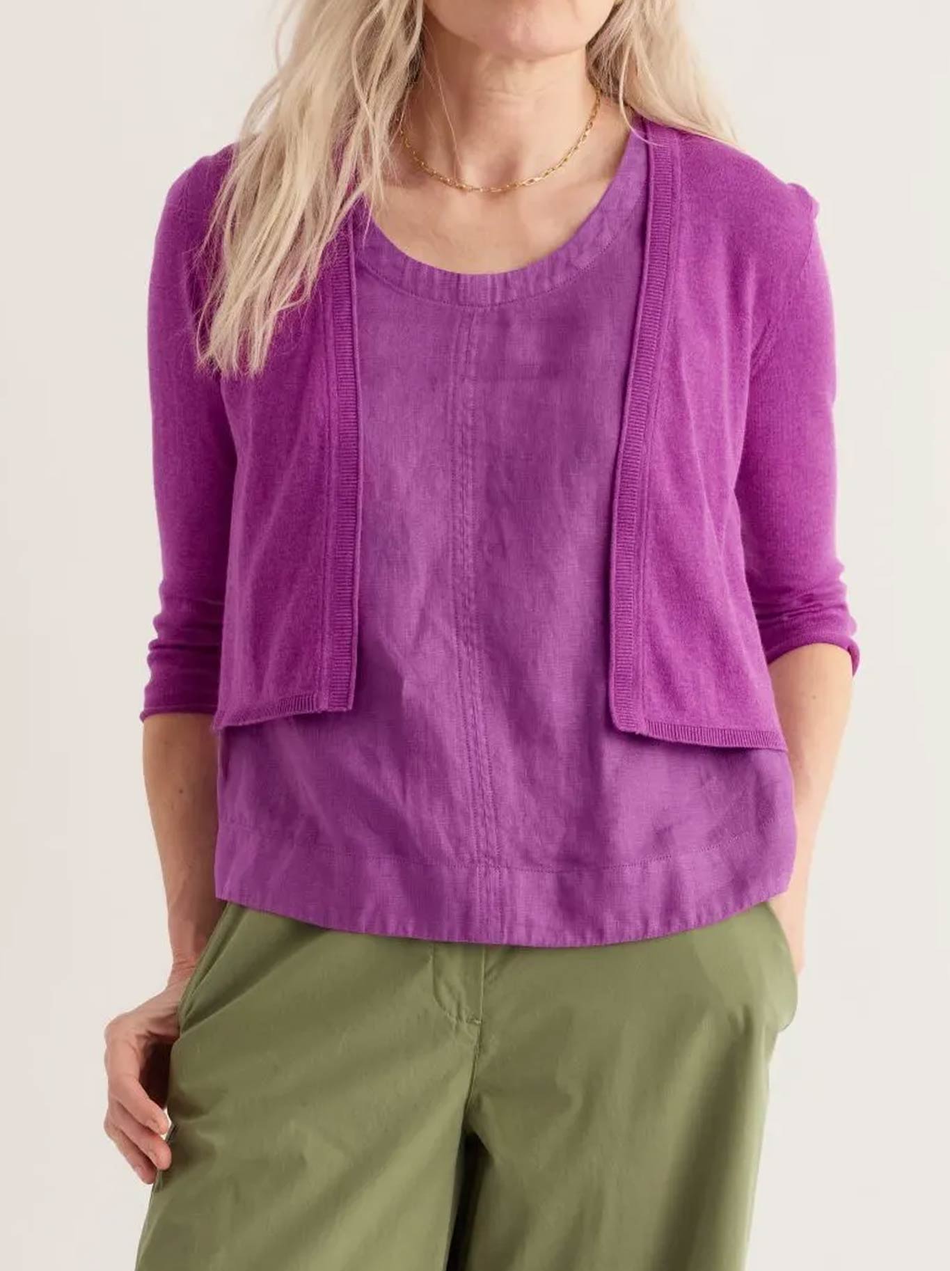 Image of a model wearing Outerwear. Product name - Seasalt Vanessa Cardigan in Wild Orchid colour by brand - Seasalt