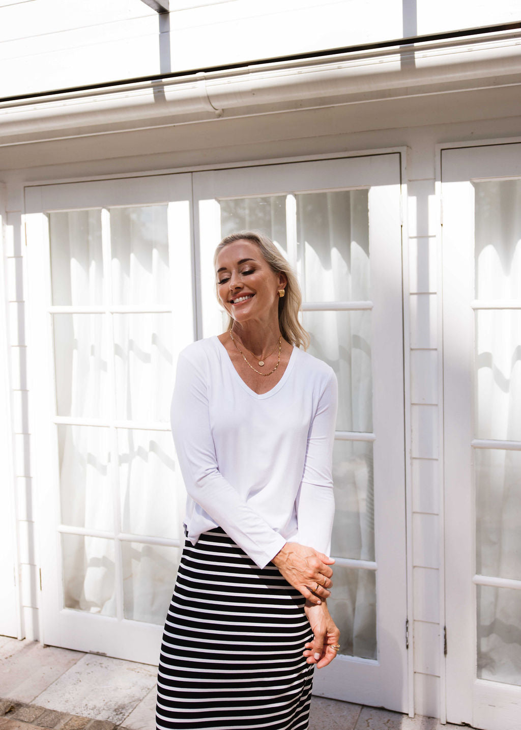Image of a model wearing Tops. Product name - The V-Neck Set in Default Title colour by brand - Lou Lou