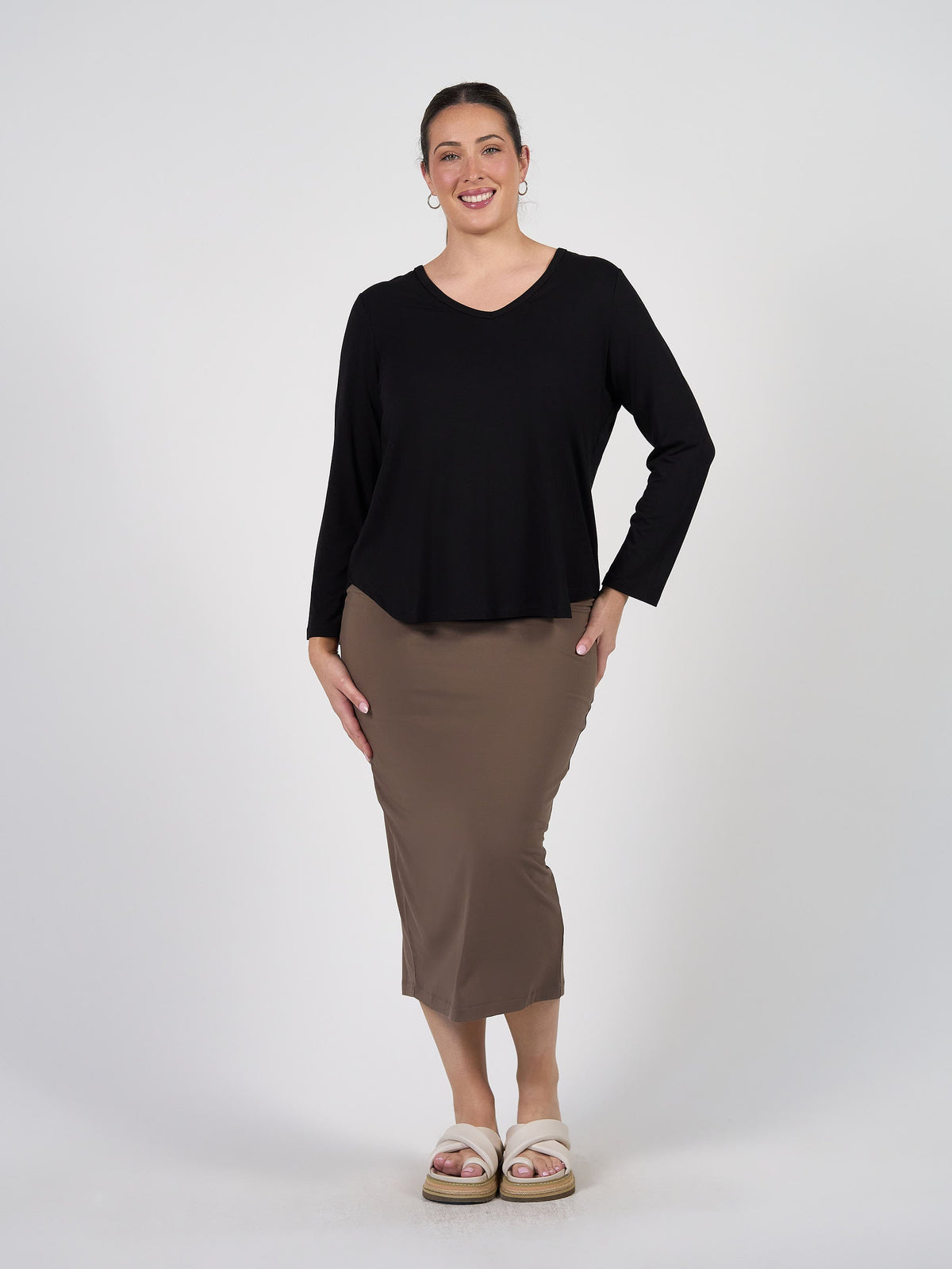 Image of a model wearing Tops. Product name - Sia V Neck Bamboo Longsleeve Top Black in Black colour by brand - Lou Lou