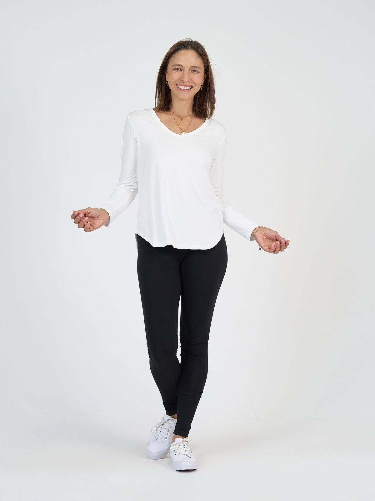 Image of a model wearing Tops. Product name - Sia V Neck Bamboo Longsleeve Top Cream in Cream colour by brand - Lou Lou