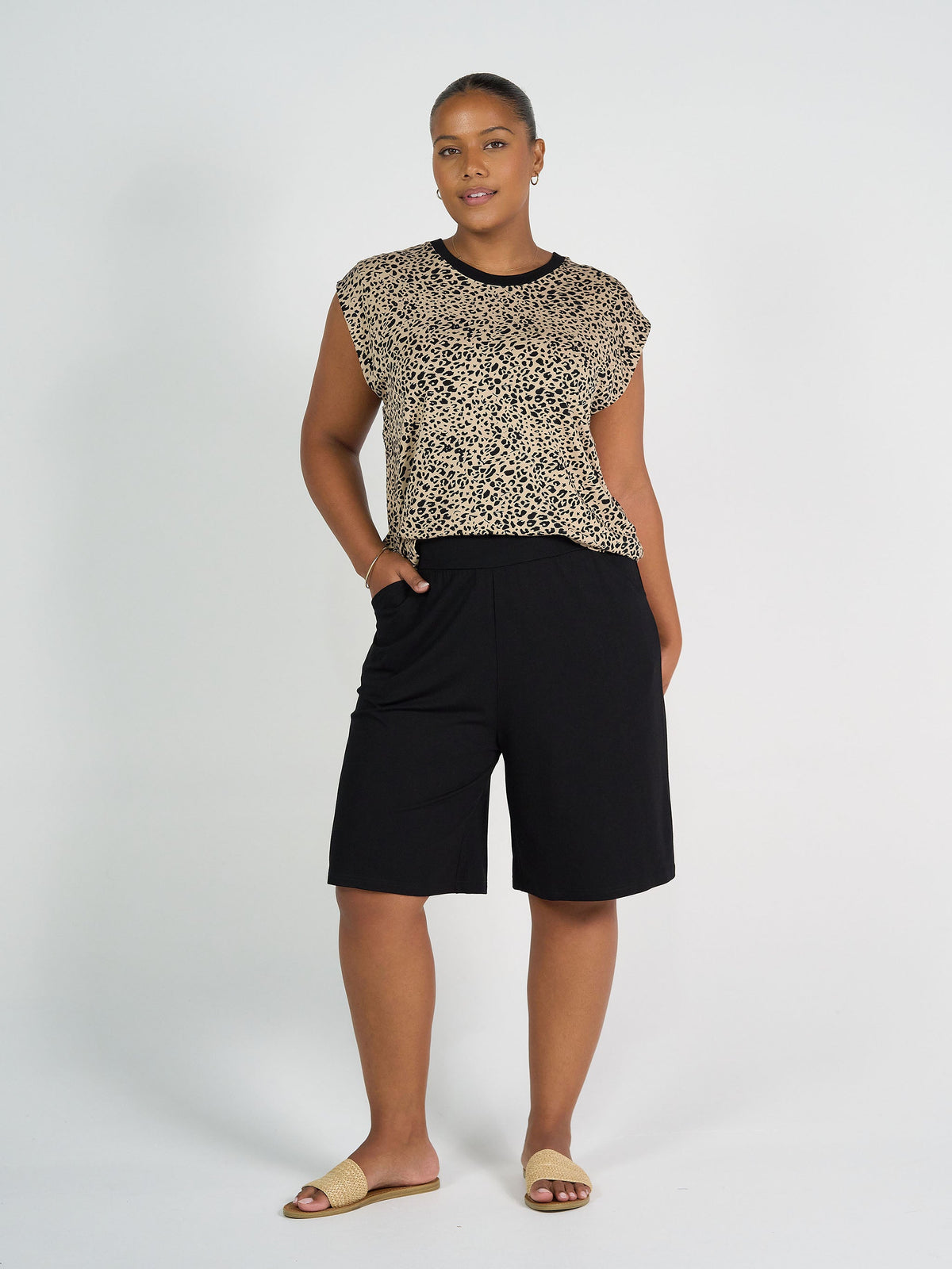 Image of a model wearing Shorts. Product name - Simone Wide Leg Bamboo Shorts Black in Black colour by brand - Lou Lou