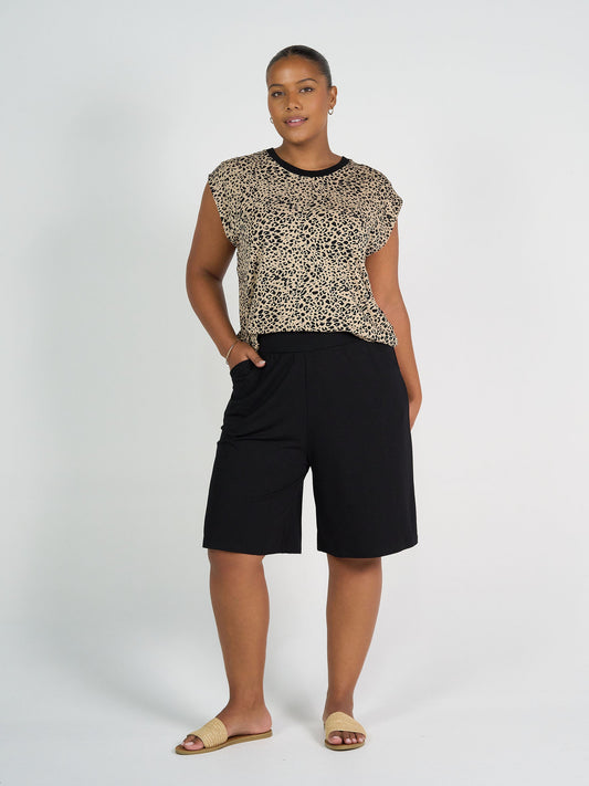 Image of a model wearing Shorts. Product name - Simone Wide Leg Bamboo Shorts Black in Black colour by brand - Lou Lou