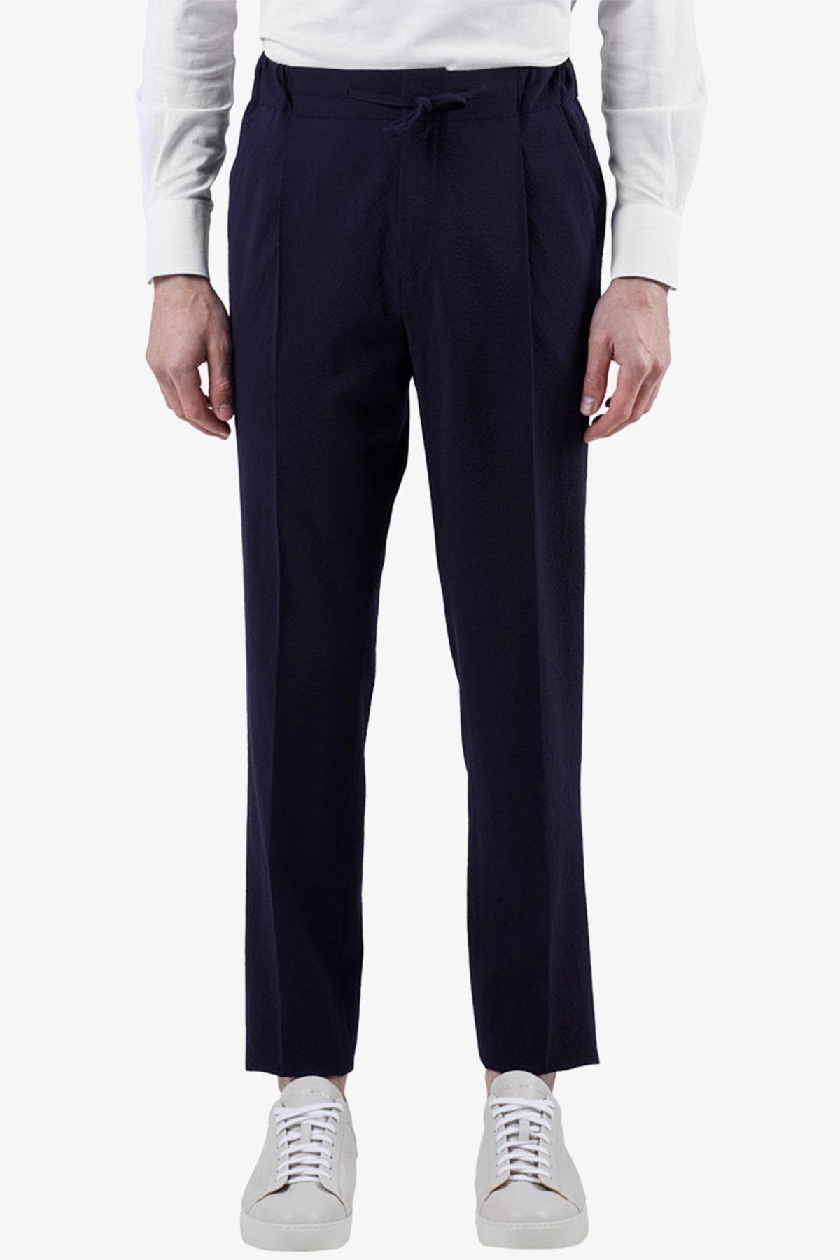 Image of a model wearing Pants. Product name - Sirenuse Navy Drawstring Pant in Navy colour by brand - Anthony Squires