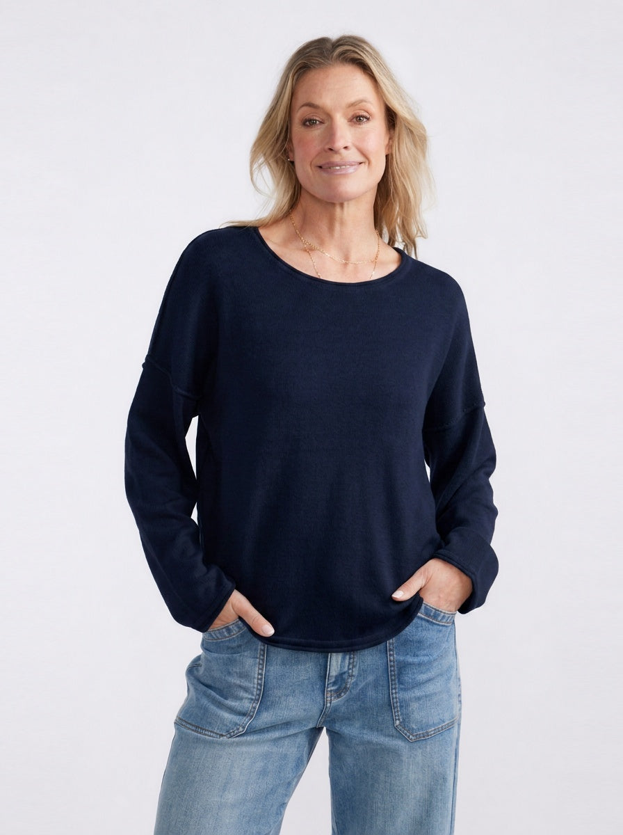 Image of a model wearing Outerwear. Product name - Sorrento Raw Edge Knit French Navy in French Navy colour by brand - White & Co.