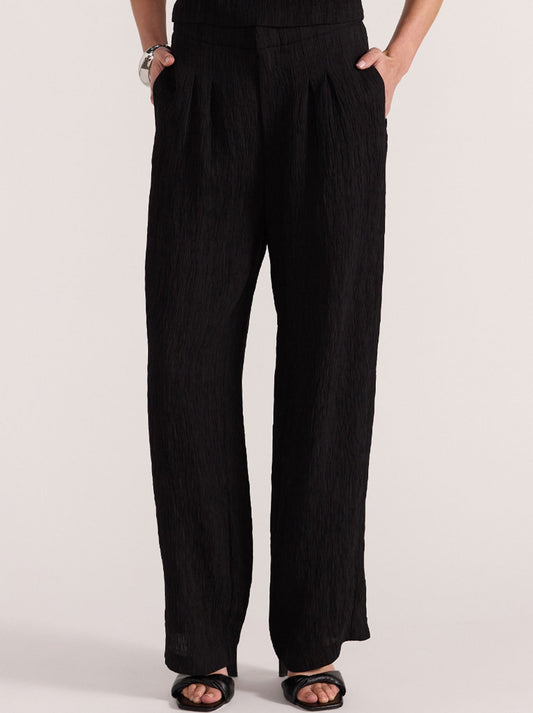 Image of a model wearing Pants. Productname: STAPLE THE LABEL EMORY PANT in Black colour by brand - Staple
