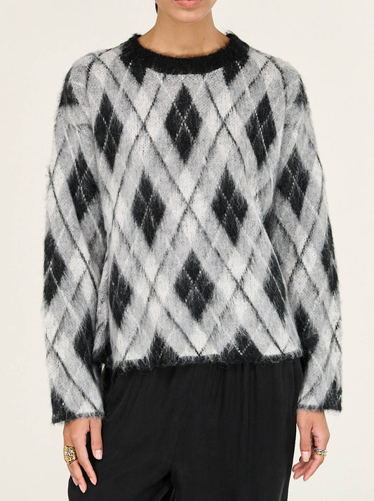 Image of a model wearing Outerwear. Product name - STAPLE THE LABEL CAMILLE BRUSHED JUMPER in Check colour by brand - Staple