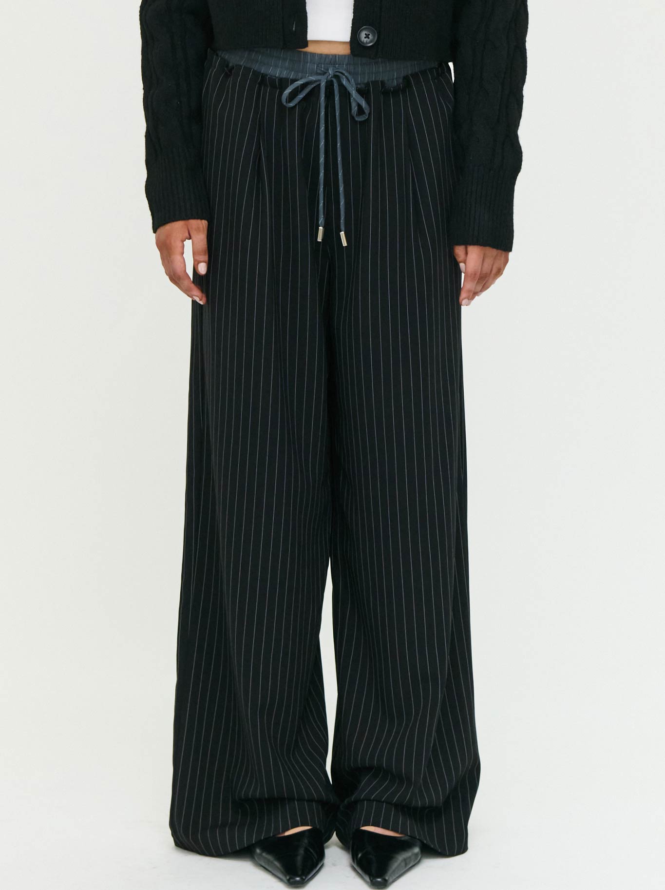 Image of a model wearing Pants. Product name - Staple The Label Rowan Relaxed Pant in Black White colour by brand - Staple