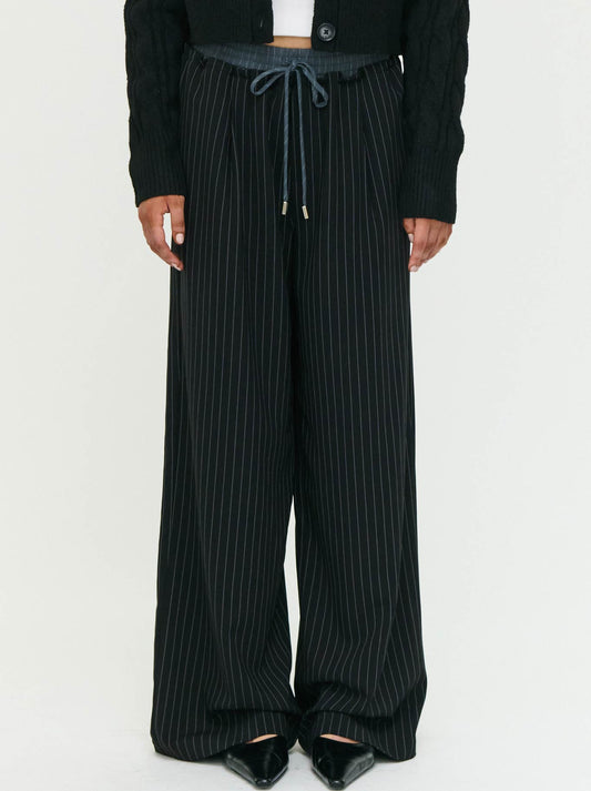 Image of a model wearing Pants. Product name - Staple The Label Rowan Relaxed Pant in Black White colour by brand - Staple