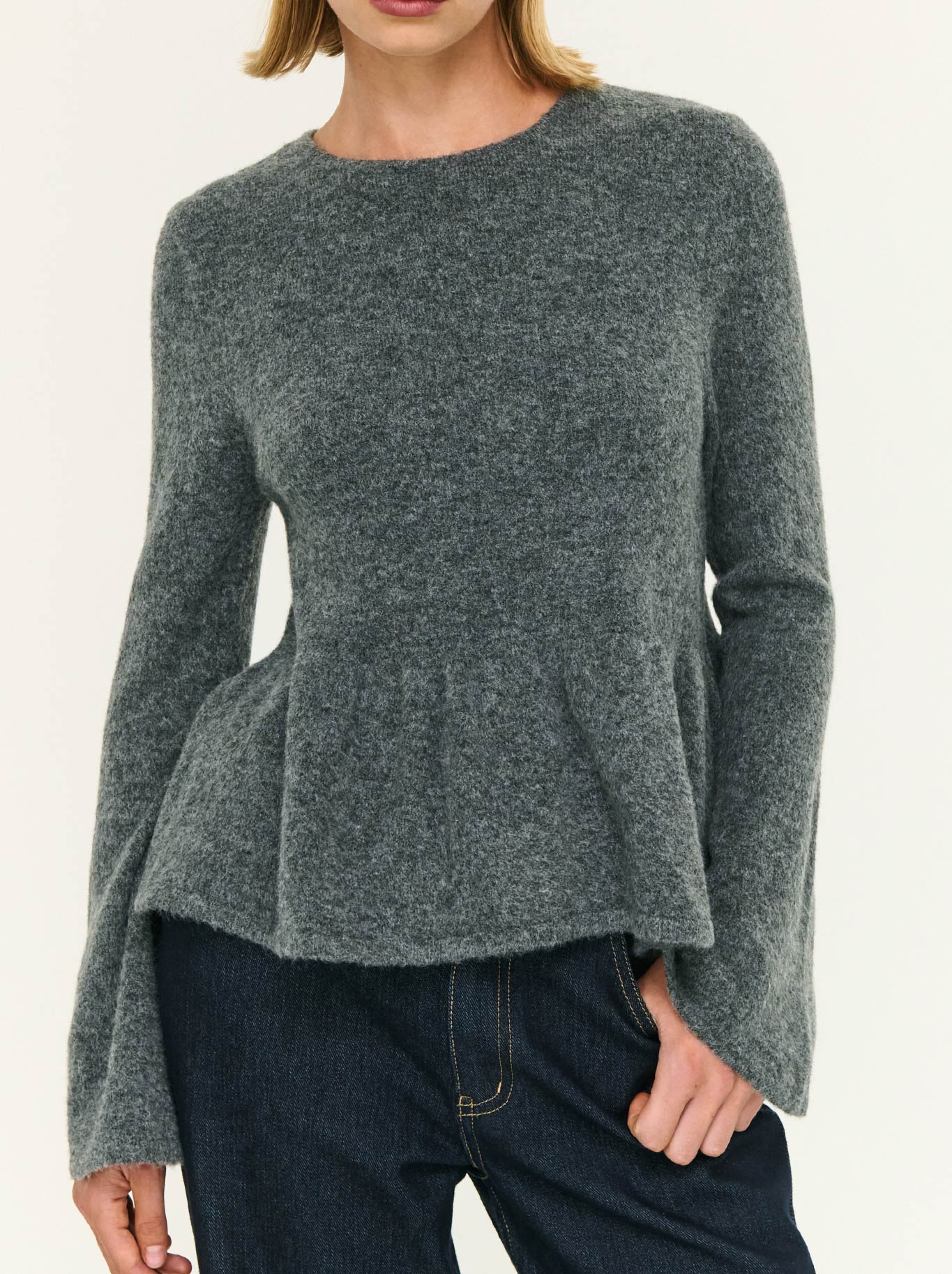 Image of a model wearing Outerwear. Product name - Staple The Label Noelle Peplum Knit Top in Charcoal colour by brand - Staple