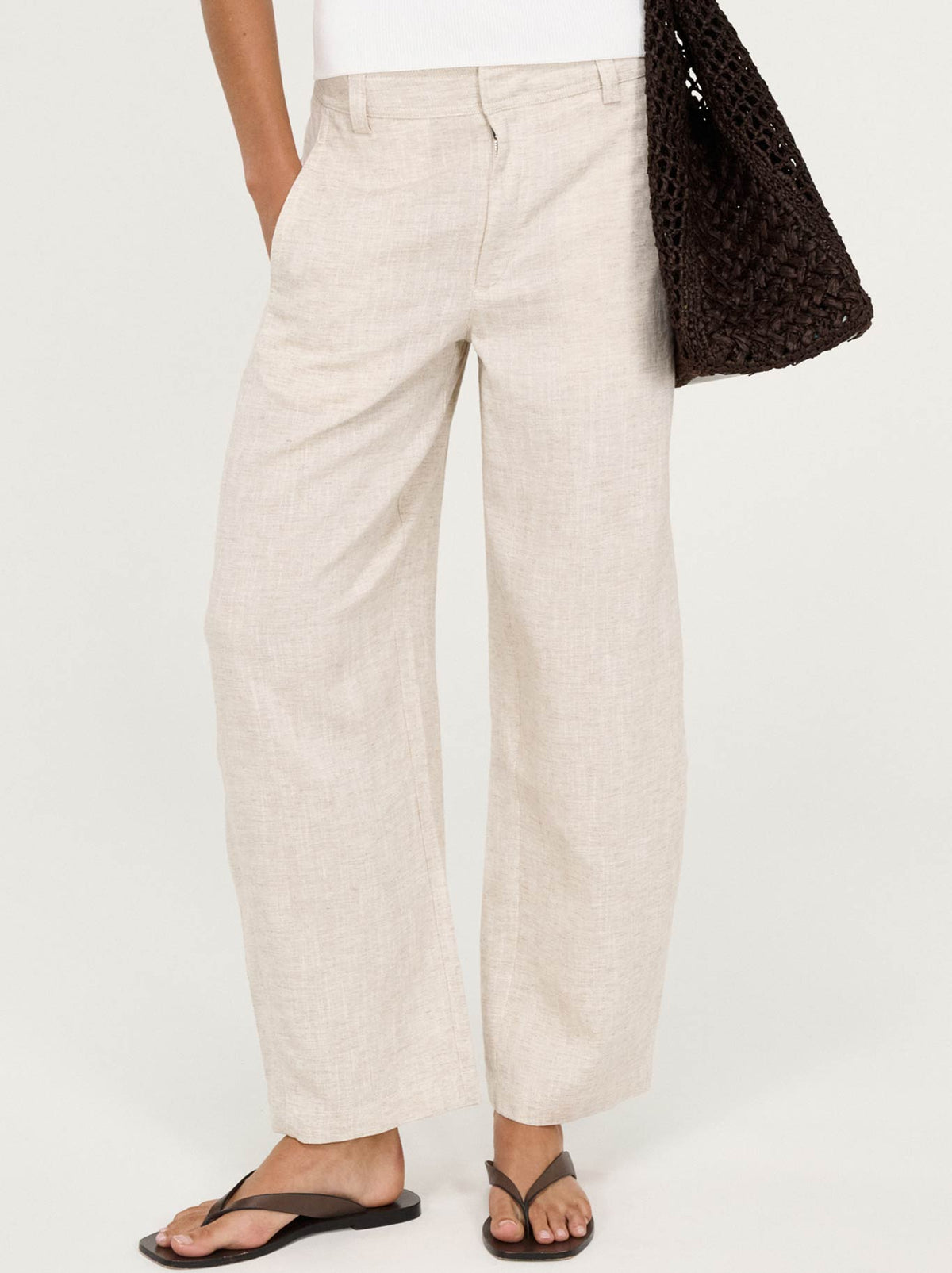 Image of a model wearing Pants. Product name - Staple The Label Neve Linen Barrel Pant in Oat colour by brand - Staple