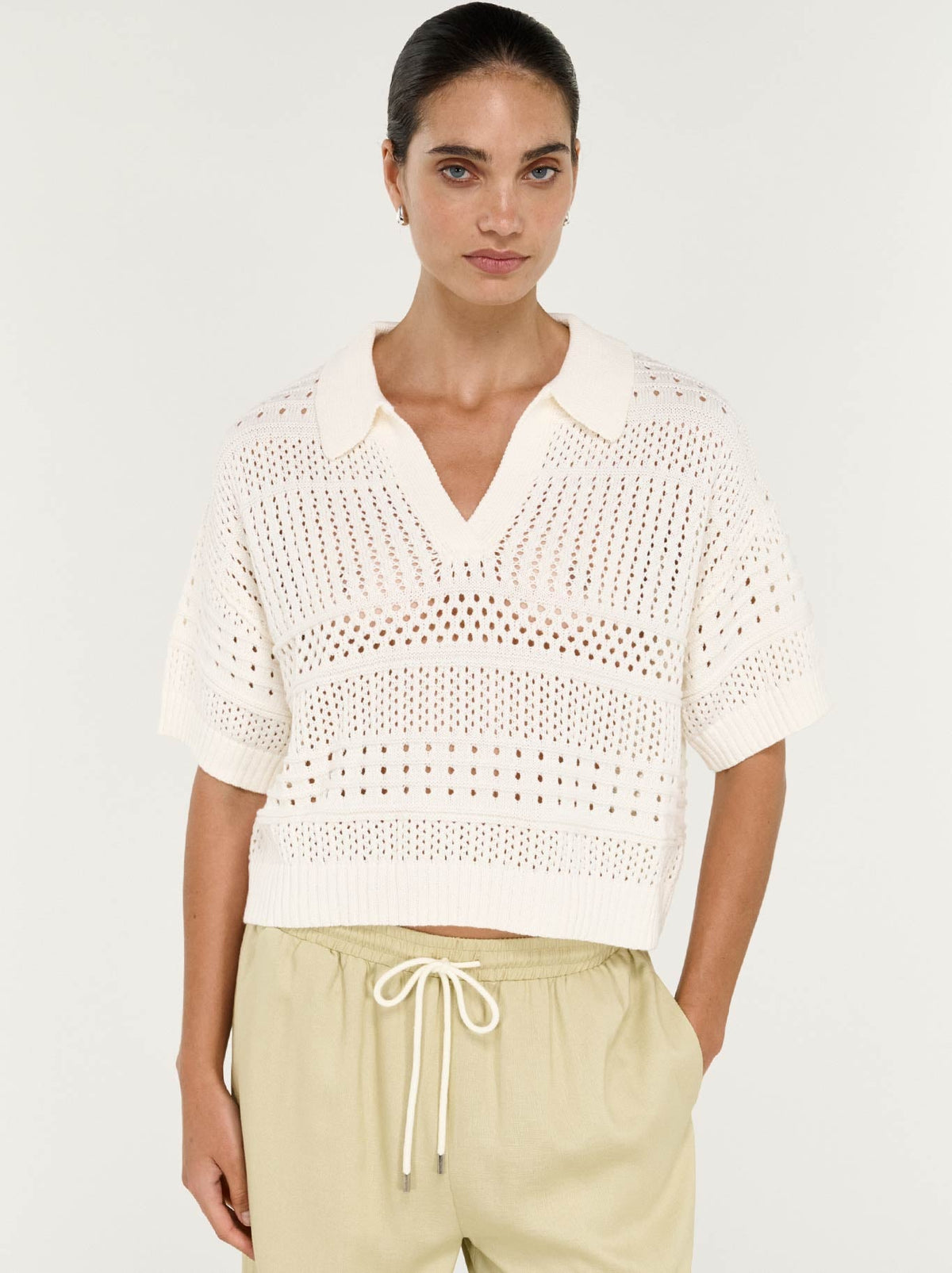 Image of a model wearing Tops. Product name - Staple The Label Nova Crochet Polo Shirt in Cream colour by brand - Staple